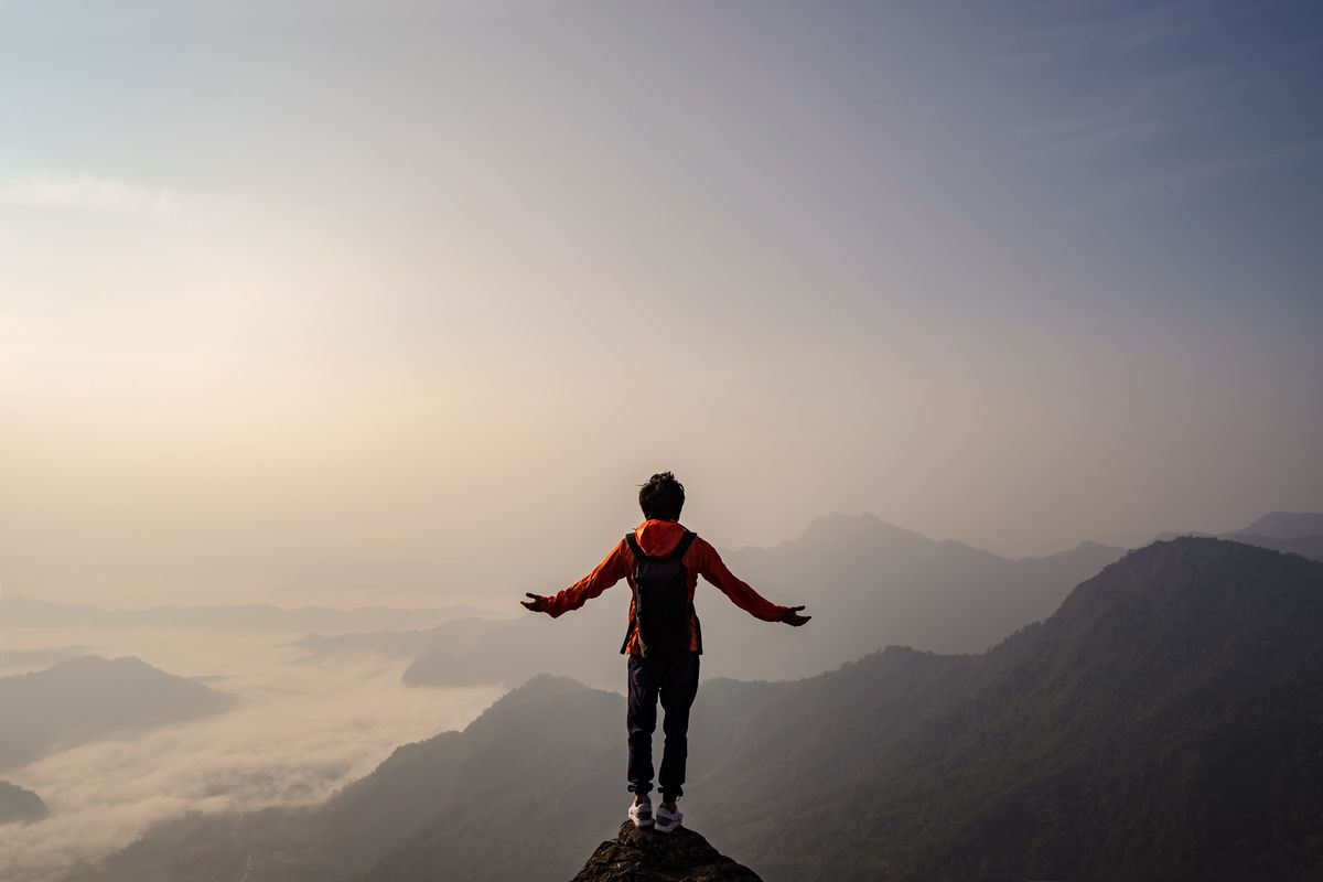 Person taking in the view at the start of a path