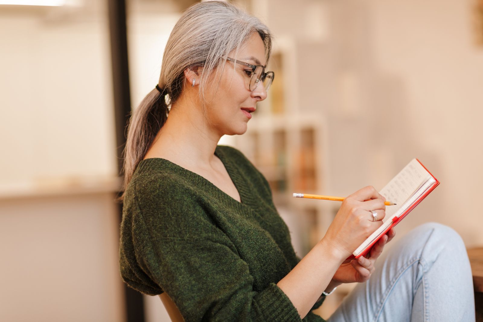Woman writing in a notebook, reflecting