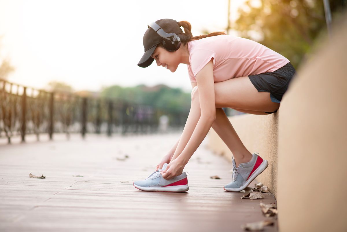 Woman tying her shoes before a walk