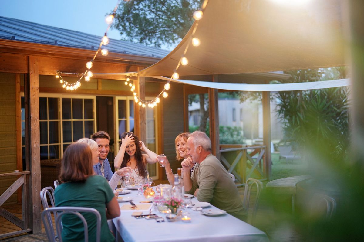 Friends sharing a meal outdoors in the evening