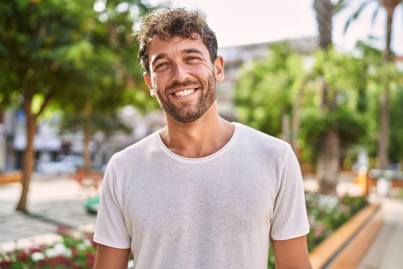 Younger man walking in a park